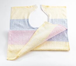 This adult bib with wide pastel stripes in yellow, pink and blue is a Terry Velcro Clothing Protector. The convenient velcro makes placing and removing simple.