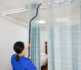 A nurse is seen here replacing the On the Right Track Disposable Privacy Curtains.