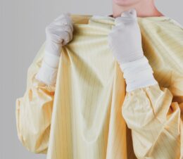 EasyRelease® Isolation Gowns feature a patented hook & loop closure at the neck and waist. The isolation gown is yellow with grey stripes and white knitted cuffs.