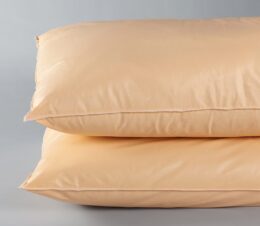 Here are two orange Sonata® Pillows stackd on topof each other. These are affordable bulk hospital pillows.