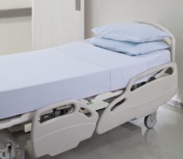 PerVal® Woven Sheeting for hospitals and health systems. Available in flat sheet, pillowcase, contour sheet, or draw sheet. Shown here on a hospital bed.