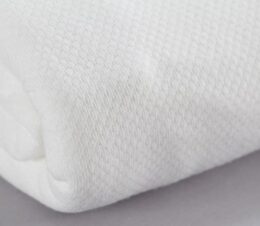 Texturized Fitted Sheets for healthcare facilities featured in the color Bleached white. Detail shot to show texturized fabric.