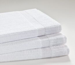 Stack of three Excel Hospital towels showing the ribbed weave sides that strengthens the portion of the towel that typically breaks down.