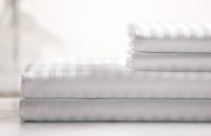 Image of a stack of luxury striped sheets.