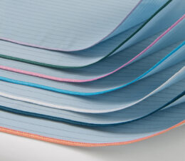 WraPel® Surgical Wrappers are stacked to show the merrowed edges. The color coded merrowed edge indicates size of the wrapper.